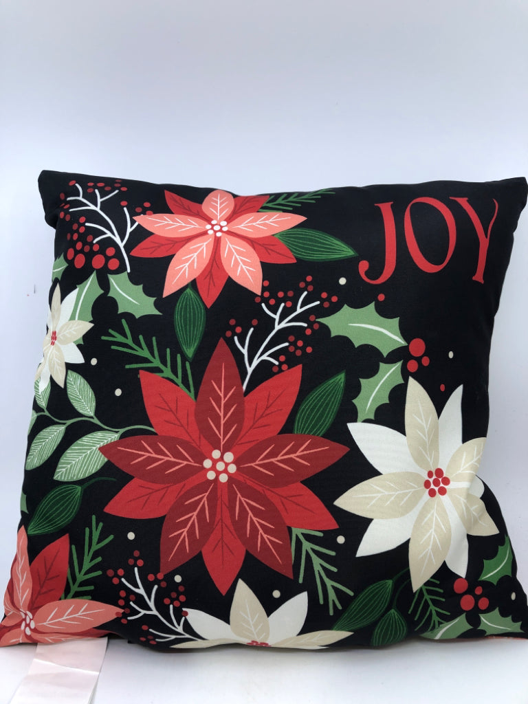 JOY BLACK ACCENT PILLOW WITH DECORATIVE FLOWERS.