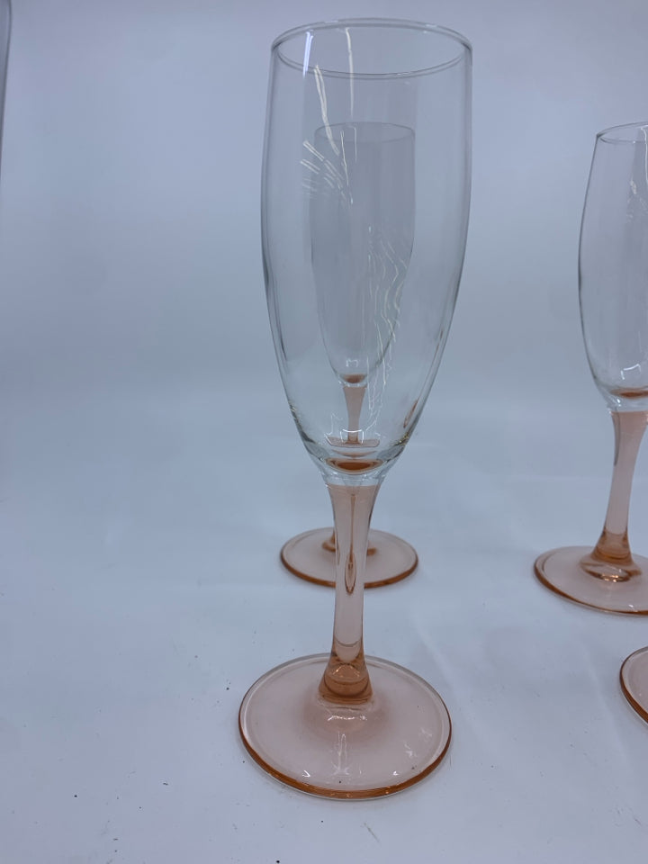 4 CHAMPAGNE FLUTES WITH PEACH COLORED STEM.