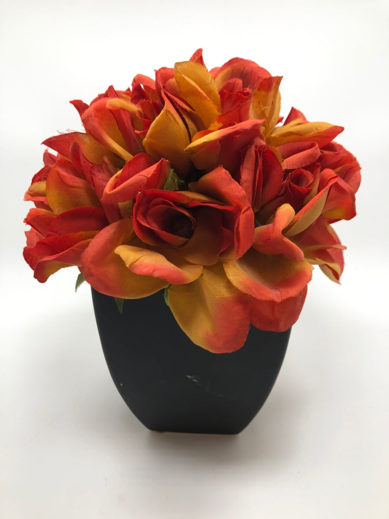 ORANGE FLOWERS IN BLACK POT.