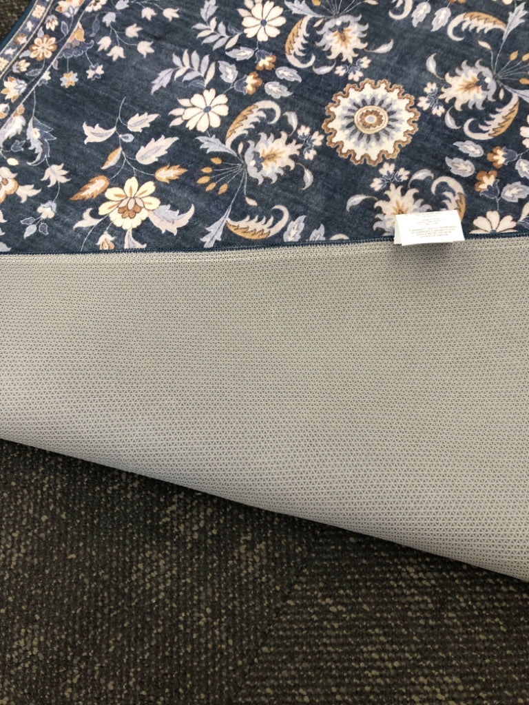 THIN BLUE FLORAL RUG W/YELLOW PETALS.