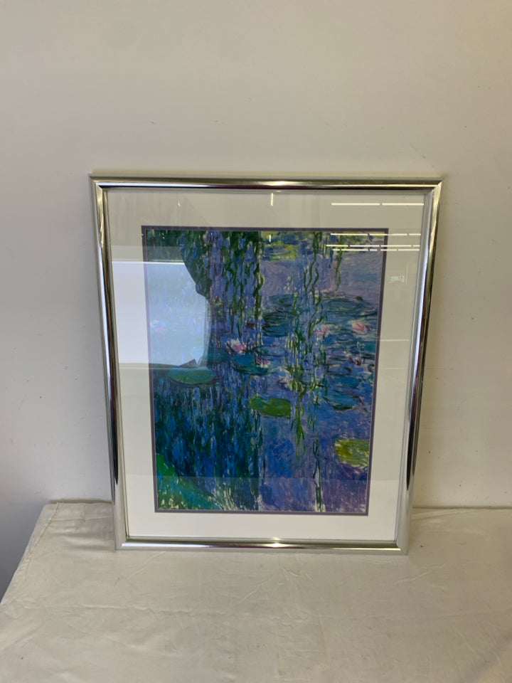 ABSTRACT LILY POND SCENE WALL HANGING IN SILVER FRAME.
