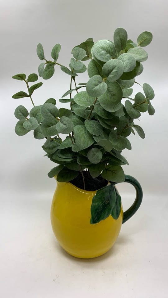 FAUX EUCALYPTUS IN YELLOW CERAMIC PITCHER.