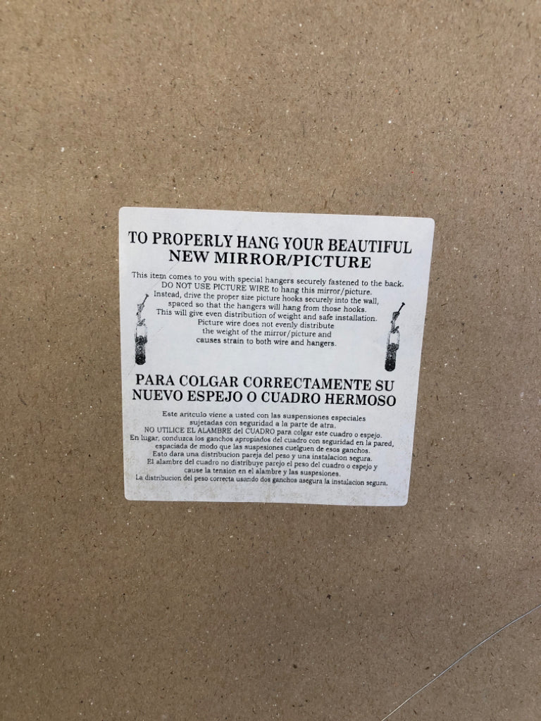 WHITE FLOWER IN LARGE BLACK FRAME.