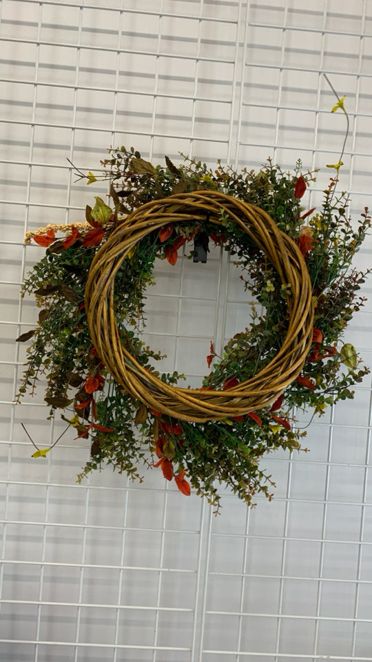 FAUX ORANGE AND GREENS WOVEN WREATH.