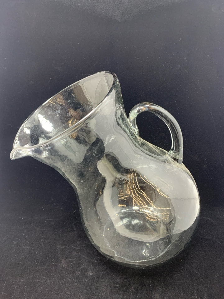 TILTED BLOWN GLASS PITCHER.