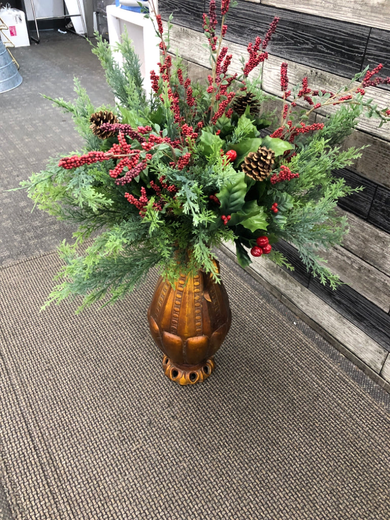LG ORANGE/BRASS POT W/WINTER FAUX GREENS + PINECONES.