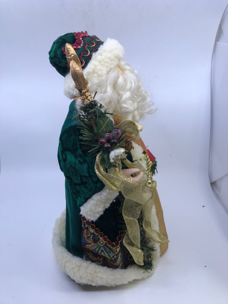 STANDING HOLLOW SANTA W/ DARK GREEN JACKET HOLDING STAKE.