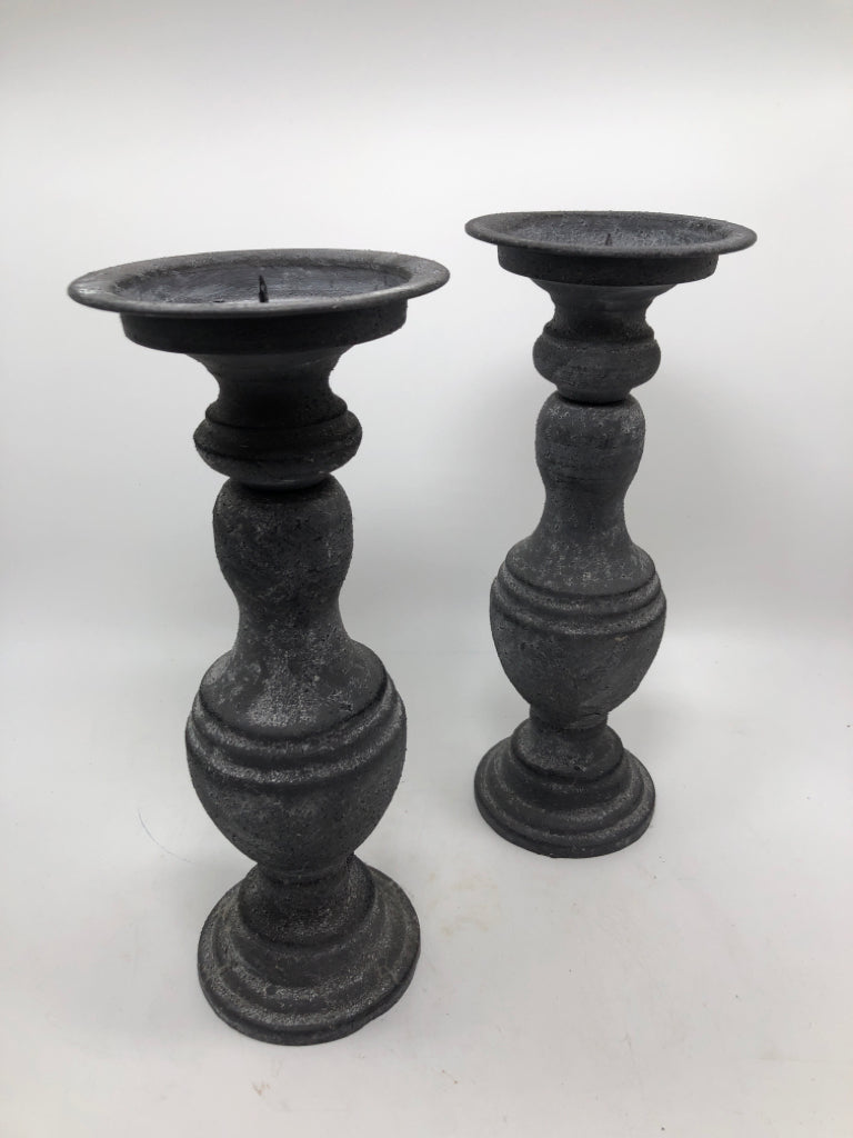 2 GREY METAL CANDLESTICK HOLDERS.