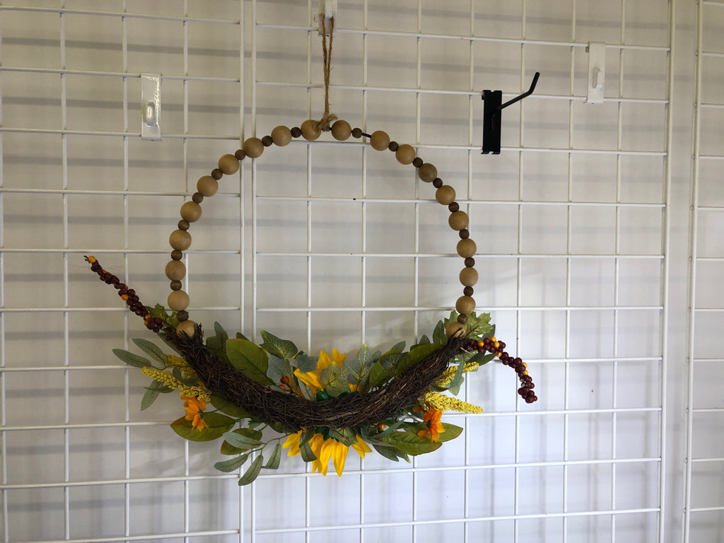 WOOD BEADED WREATH W/ FAUX SUNFLOWER.