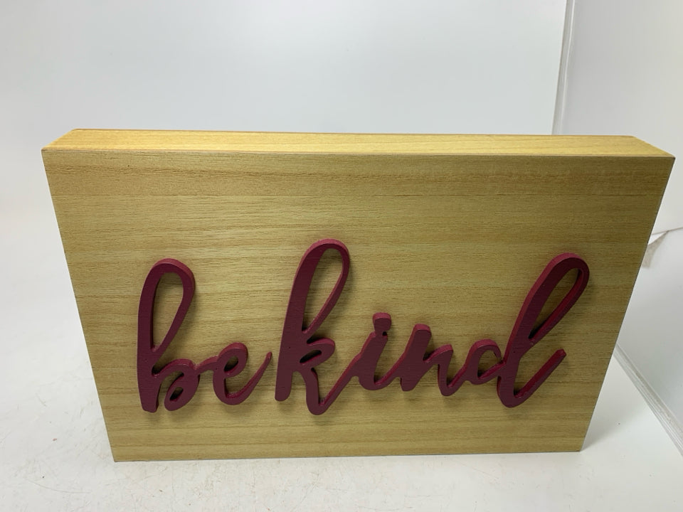 BE KIND IN MAROON LETTERS SIGN.