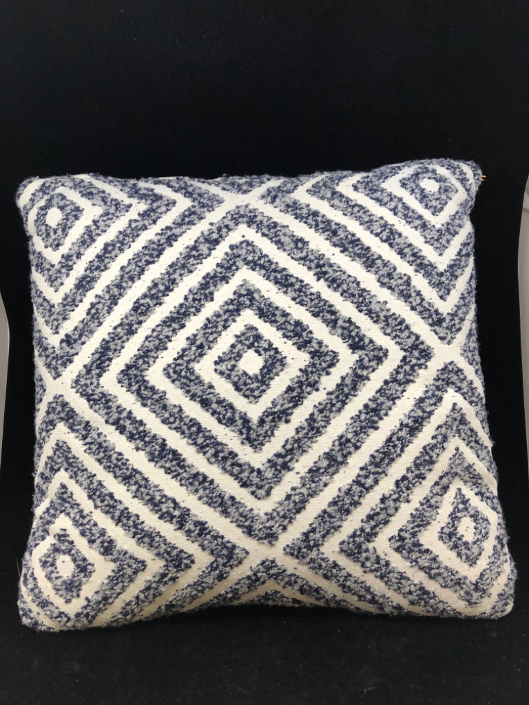 CREAM PILLOW W/BLUE TEXTURED DIAMOND DESIGN.