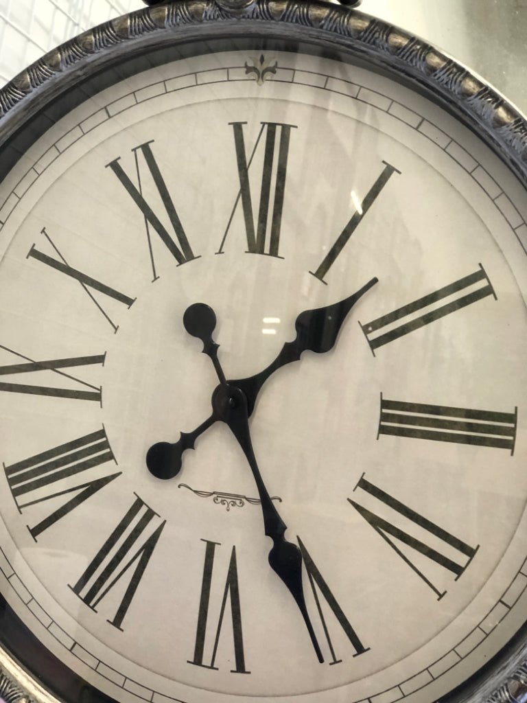 PLASTIC SILVER CLOCK W/ MIRRORS.