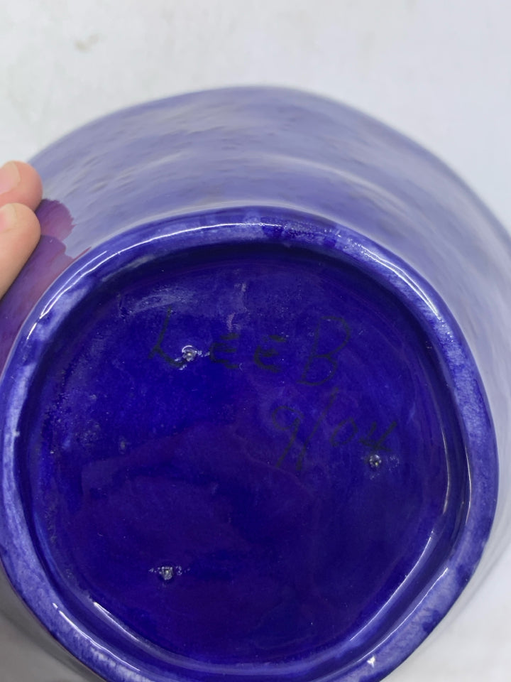 DARK BLUE CERAMIC BOWL W/ BLUE DOTS INSIDE.