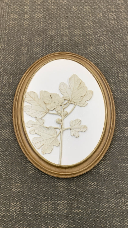 LEAVES EMBOSSED ON ROUND WOOD FRAME.