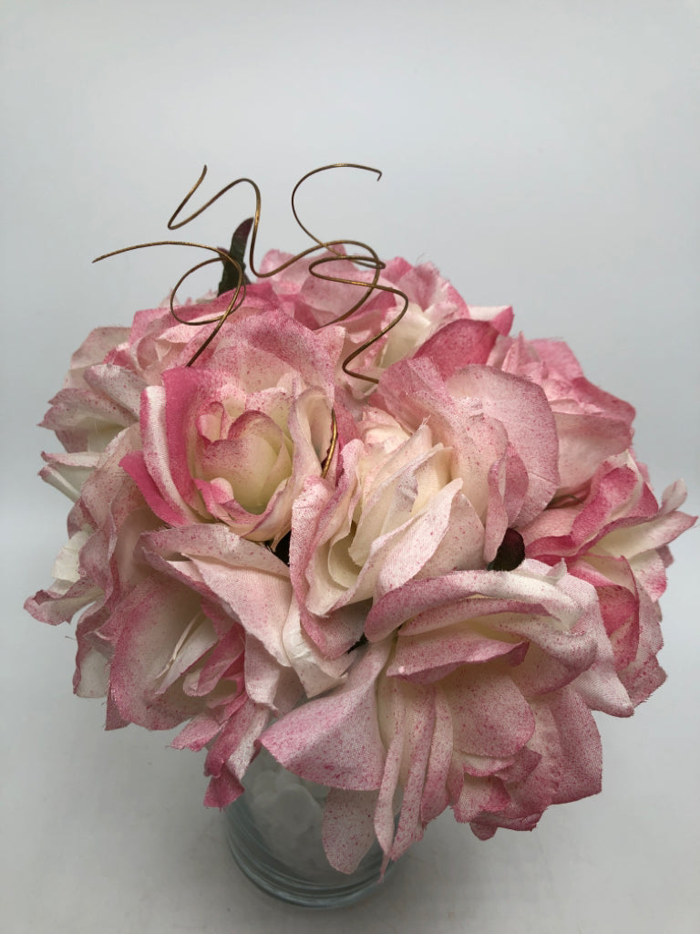 WHITE ROCK FILLED VASE W/PINK FLORALS.