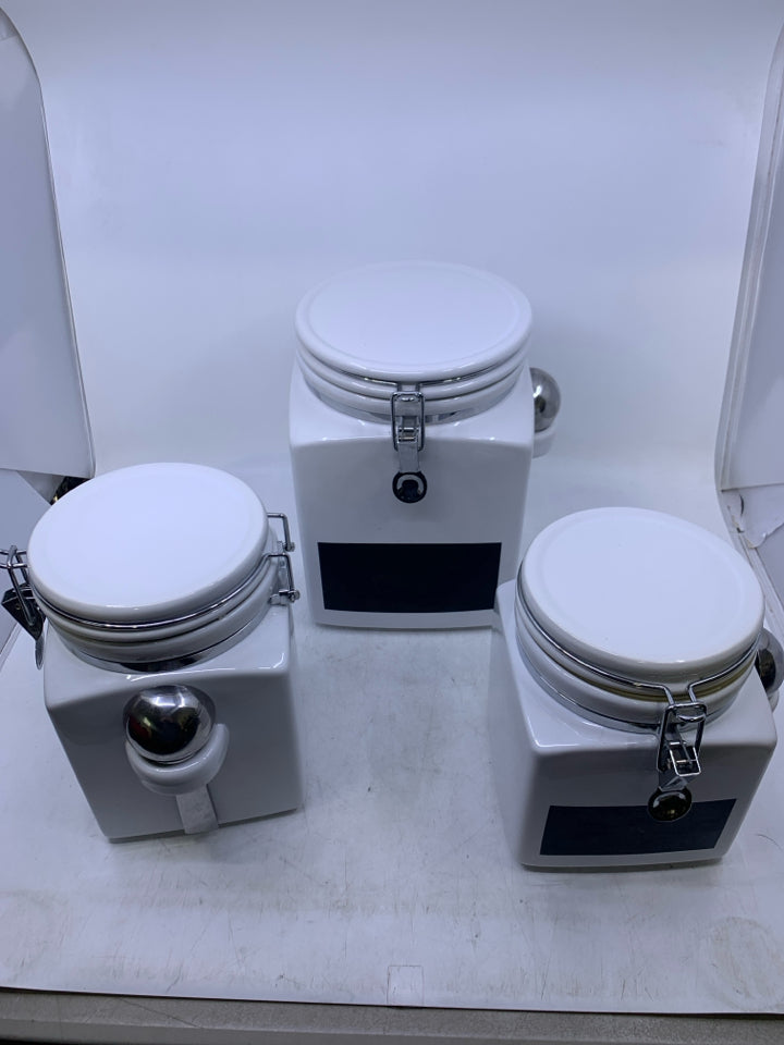 3 PC WHITE CANISTER SET W/ CHALK BOARD LABEL AND METAL SPOONS.
