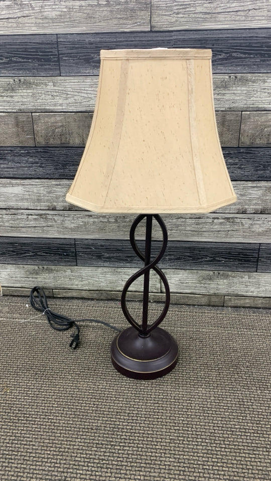 BROWN SCROLL BASE LAMP W/TAN SHADE.