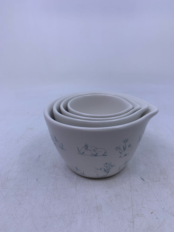 4 NESTING MEASURING CUPS W/ BLUE BUNNIES.