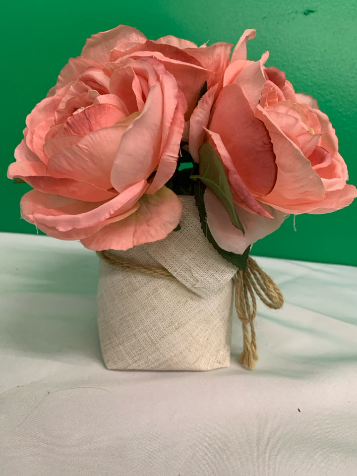 FAUX PINK FLORAL IN BURLAP PLANTER.