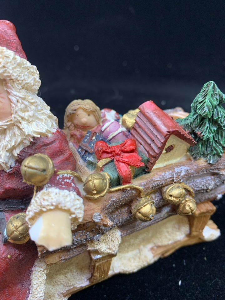 SANTA SITTING ON SLEIGH W TOYS.