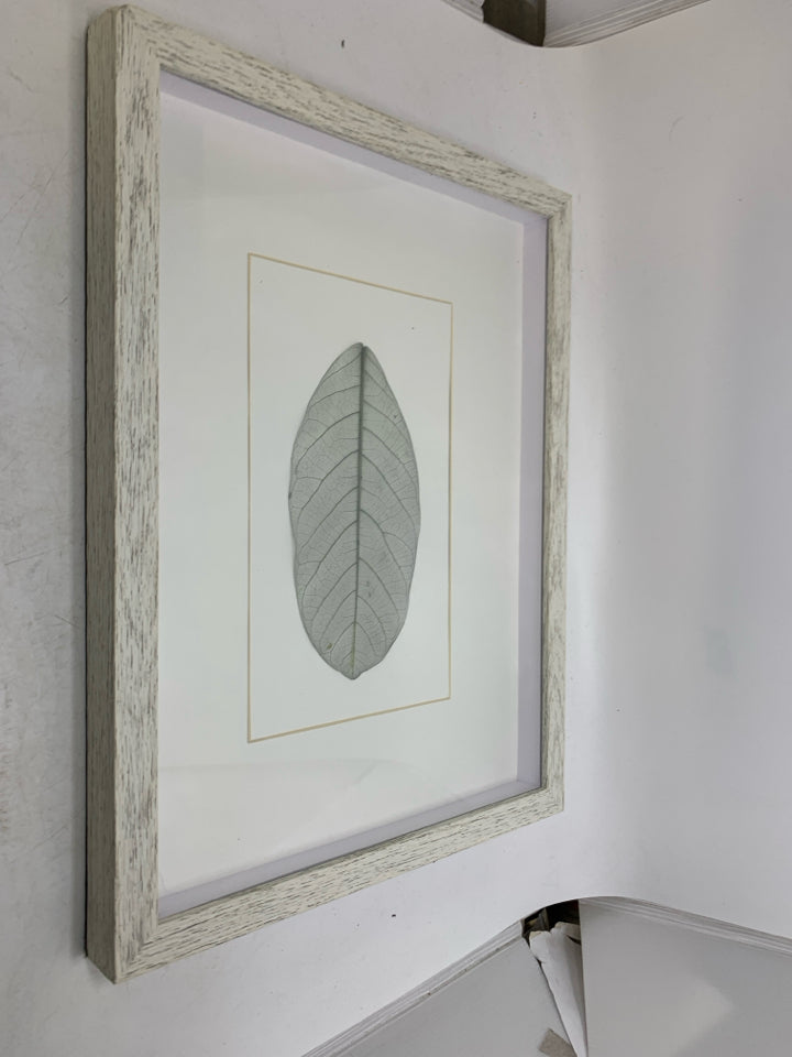 WHITE FRAME SHADOW BOX W/ LEAF IN CENTER.