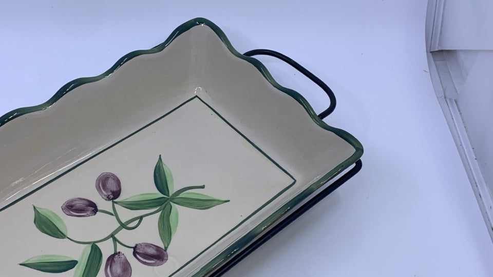 OLIVE CASSEROLE DISH IN METAL HOLDER.