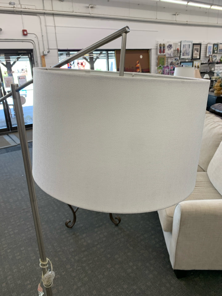 TALL SILVER FLOOR LAMP W/CREAM SHADE.
