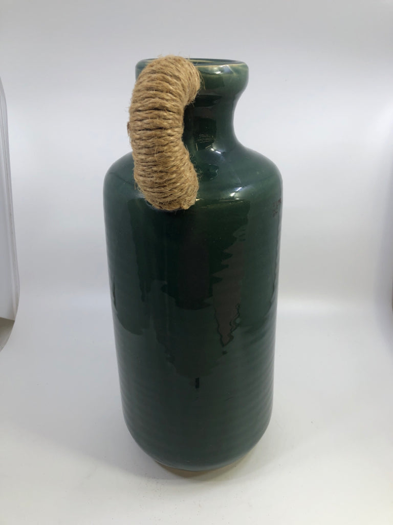 GREEN CERAMIC VASE WITH TWINE WRAPPED HANDLE.