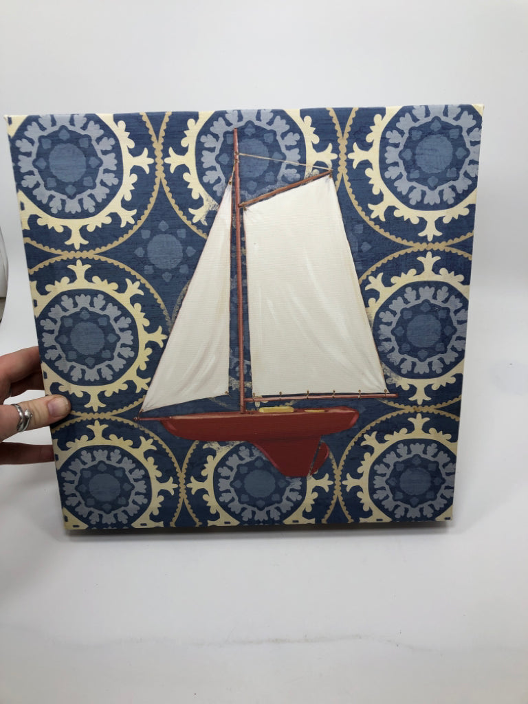 SAILBOAT PAINTED CANVAS ON BLUE BACKGROUND.