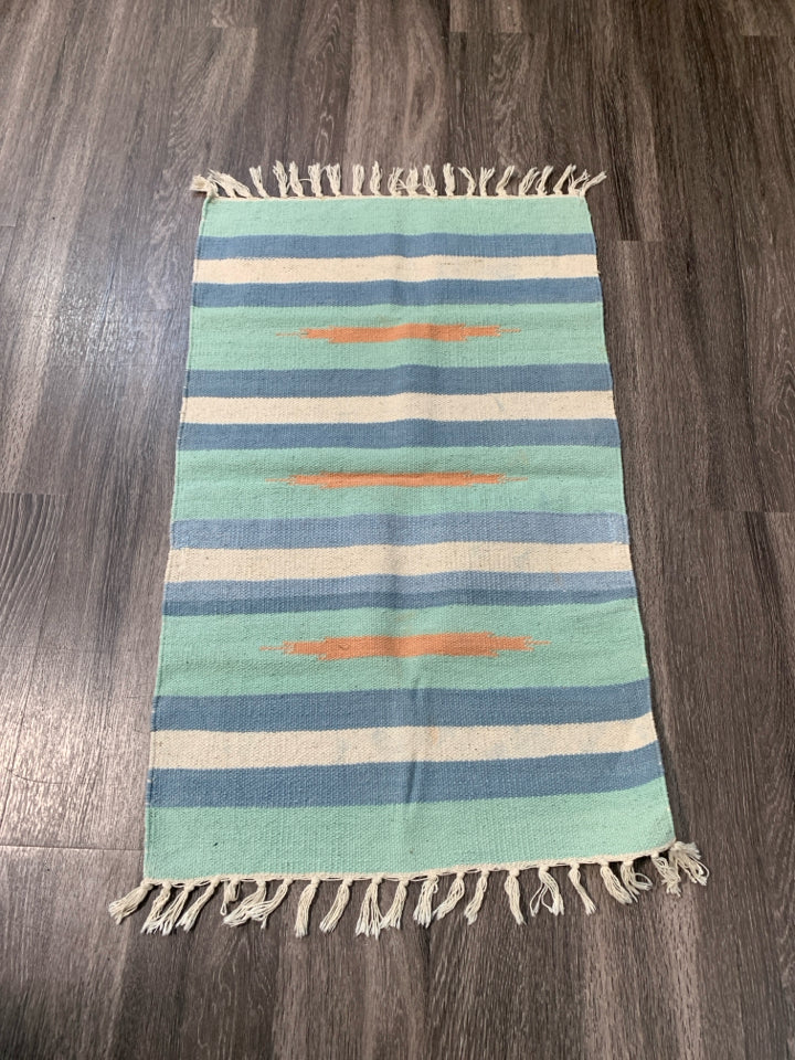 ASSORTED COLORS WOVEN AZTEC PATTERN RUG W/ TASSELS.
