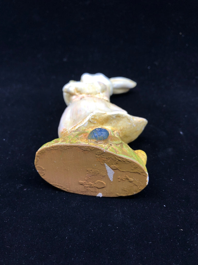 BUNNY HOLDING NET FIGURINE.