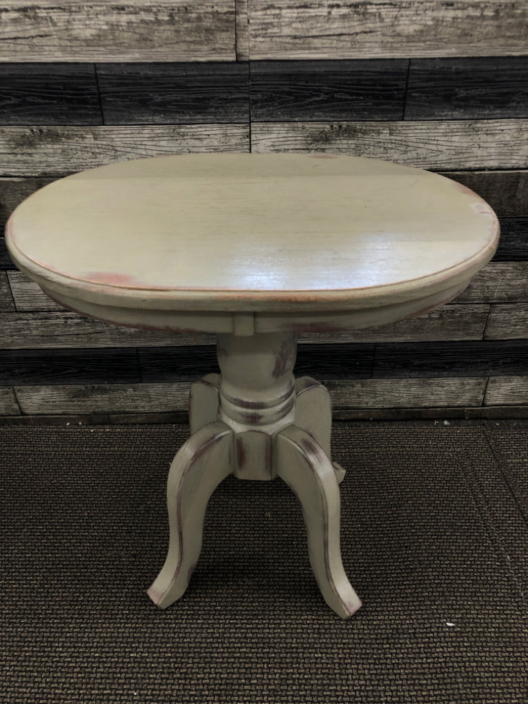 OVAL GREEN TINT DISTRESSED FOOTED SIDE TABLE.