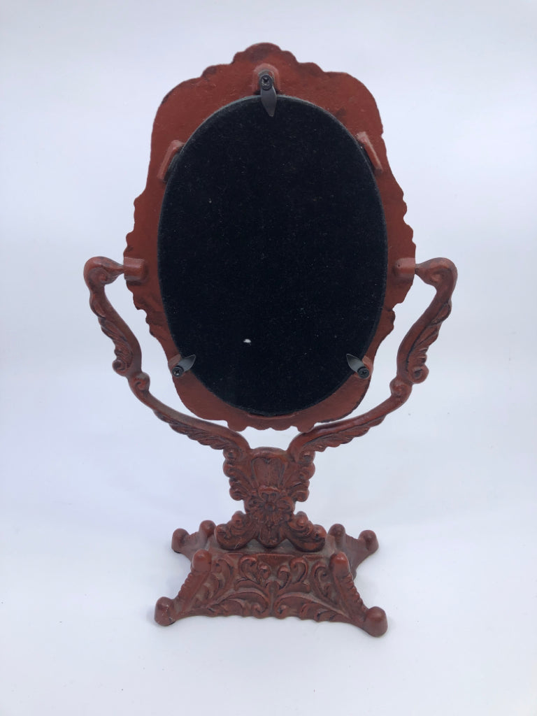 HEAVY RED METAL ORNATE MIRROR.