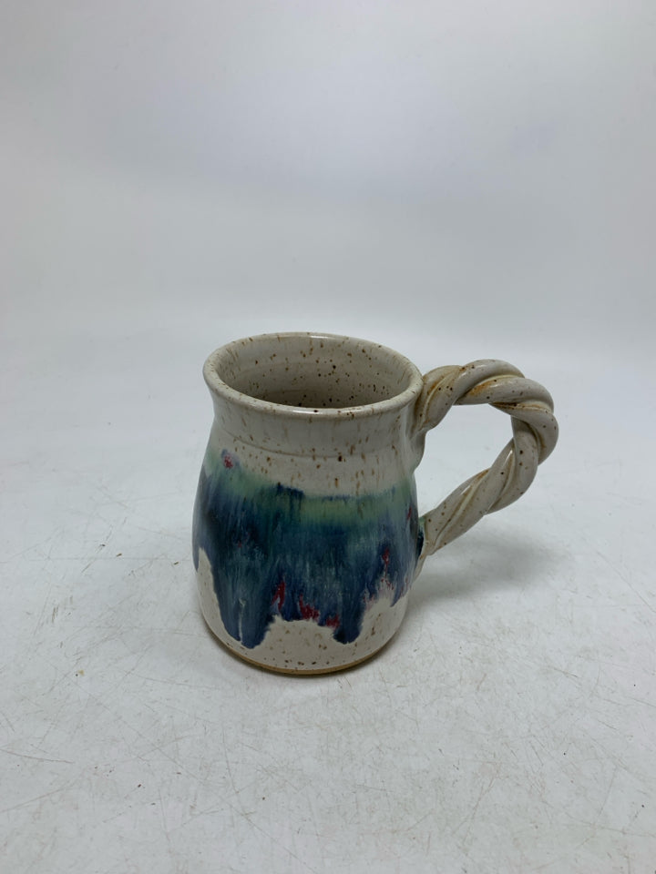 WHITE SPECKLED POTTERY MUG W/ TWISTED HANDLE BLUE DRIPS.