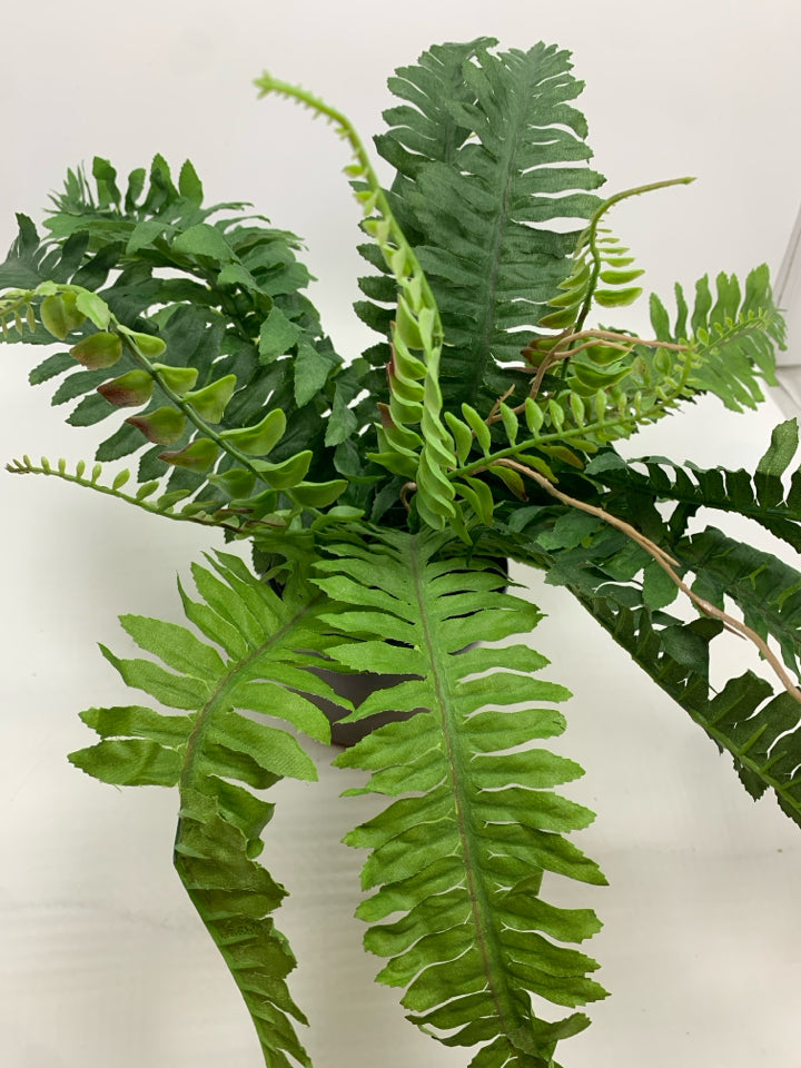 FAUX FERN IN BROWN CERAMIC POT.