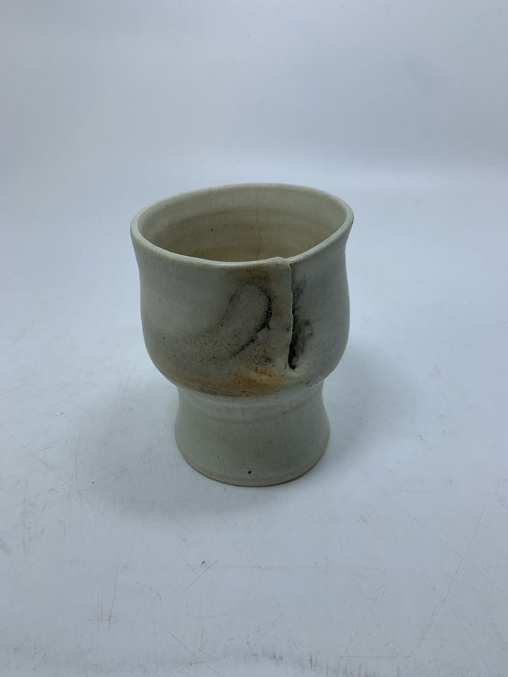 CREAM POTTERY IMPERFECT FOOTED CUP.