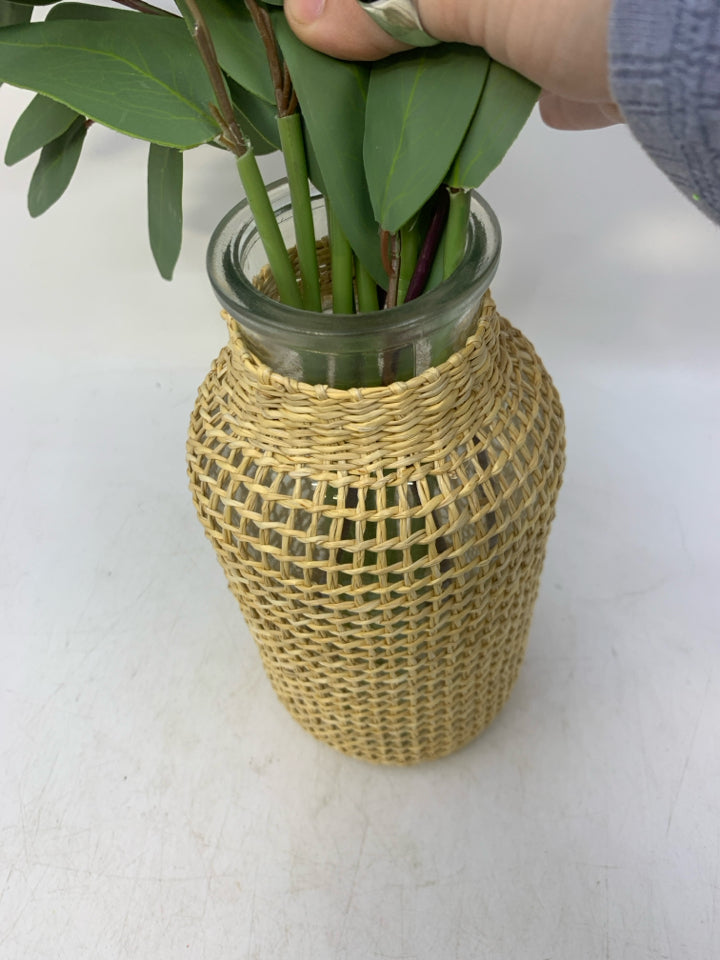 GLASS VASE W/ WOVEN WEAVE OVER IT FAUX LEAVES FILLER.