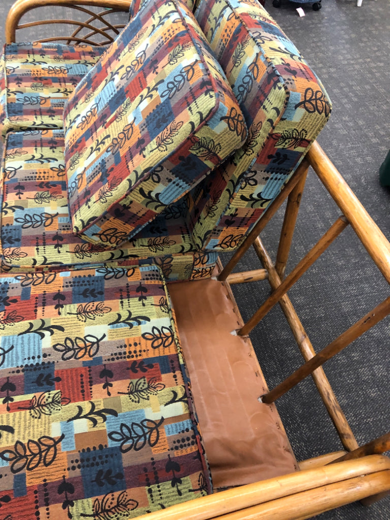 RATTAN SOFA W/PATTERNED FABRIC.