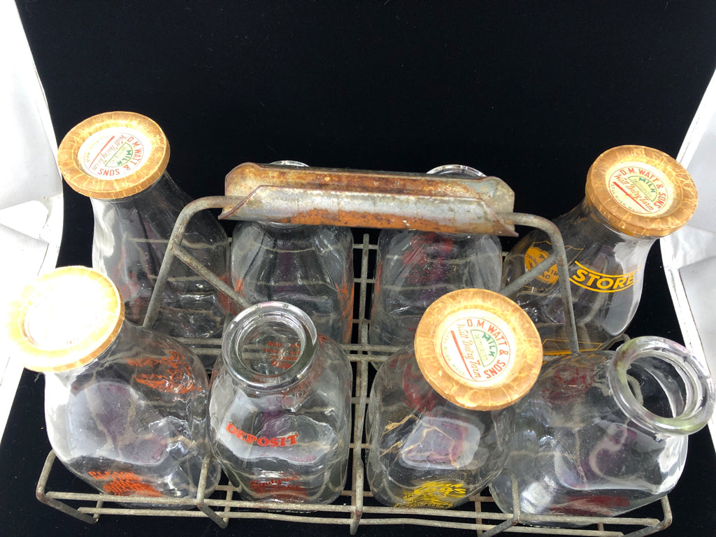 METAL CRATE + 8 DECORATIVE VTG MILK BOTTLES.