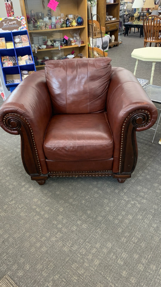 RED LEATHER CHAIR W/WOODEN UPHOLSTERY.