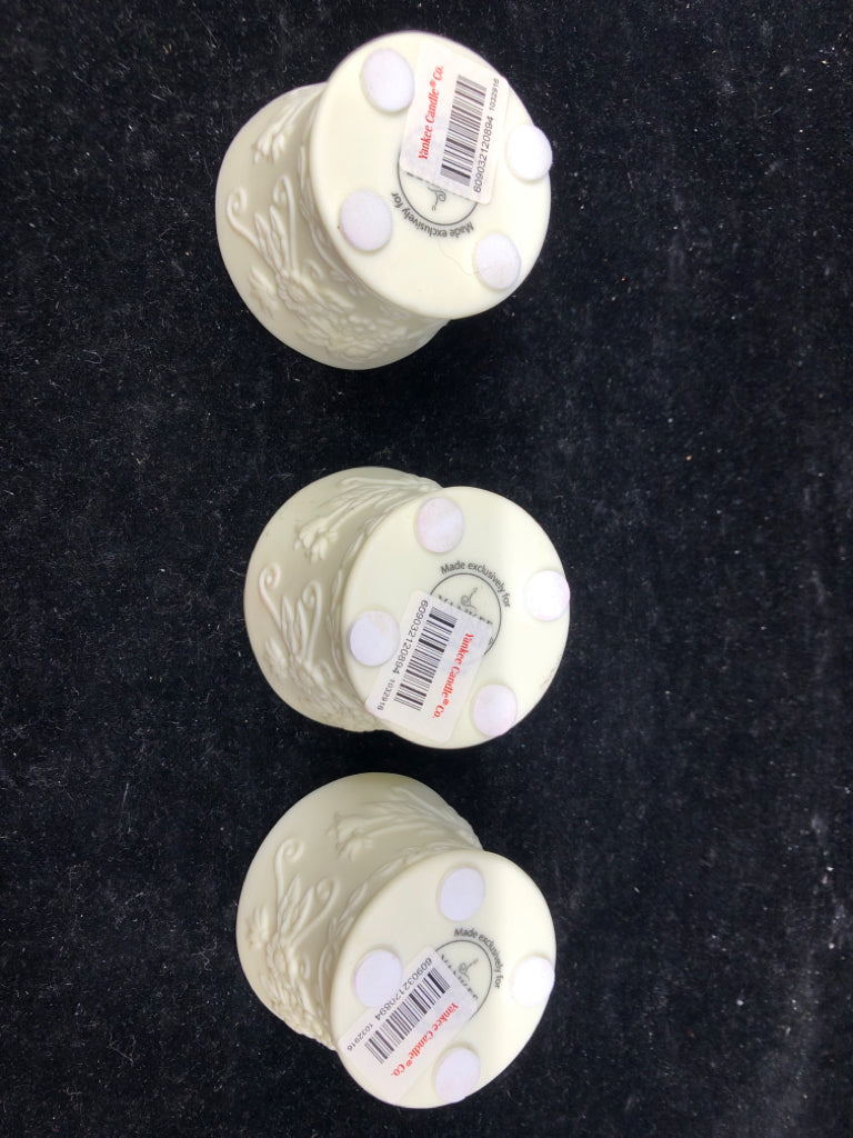 3 CREAM EMBOSSED YANKEE CANDLE TEALIGHT HOLDERS.