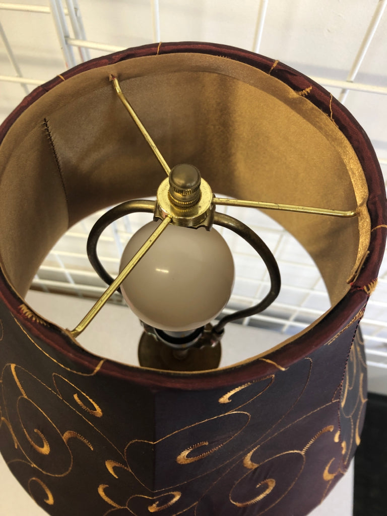 GOLD SKINNY BASE LAMP W MAROON AND GOLD ACCENTS SHADE.