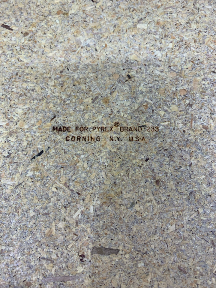 PYREX DISH W/WOVEN BASKET LEATHER HANDLES.