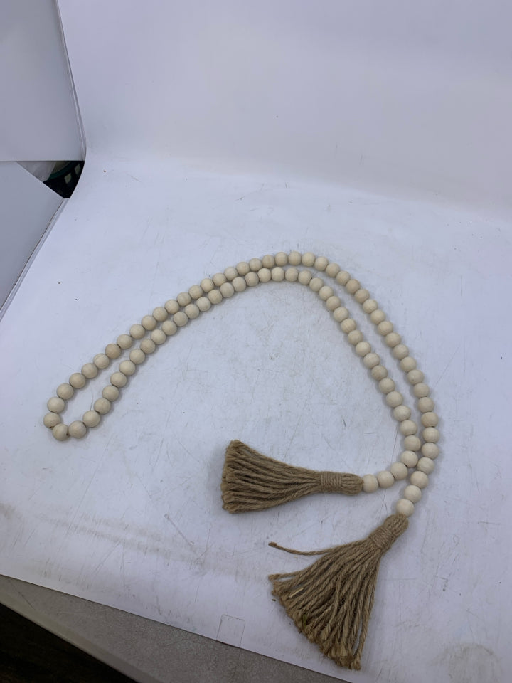 LIGHT WOOD BEADED W/ TASSELS.