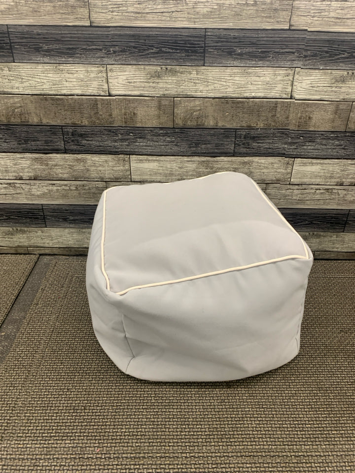 GREY CUBE OTTOMAN W WHITE ACCENT.