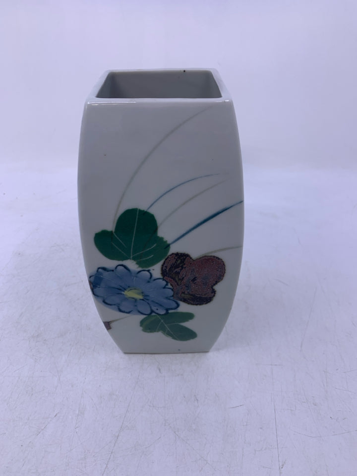 WHITE CERAMIC VASE W/ PAINTED COLORED FLOWERS.