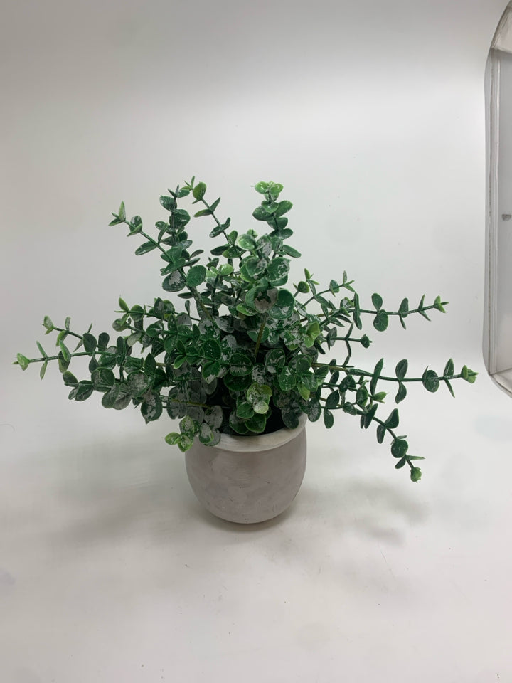 FAUX GREENS IN CEMENT POT.