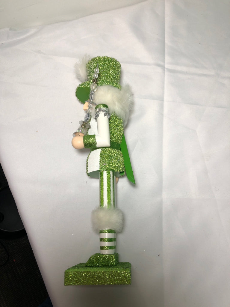 GREEN AND WHITE GLITTER NUT CRACKER.