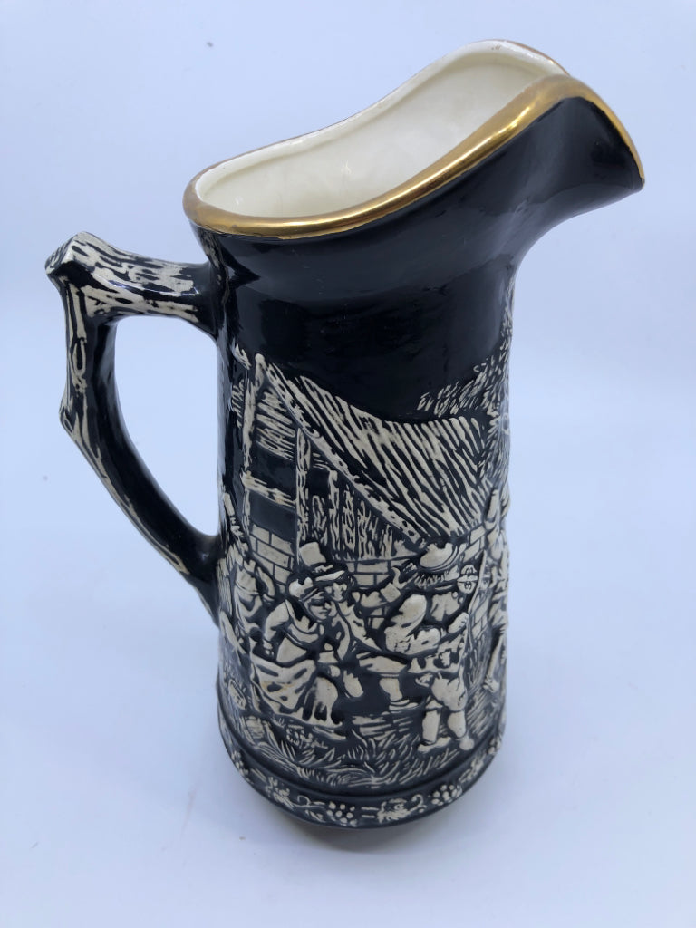 VTG BLACK W EMBOSSED PEOPLE DANCING PITCHER.