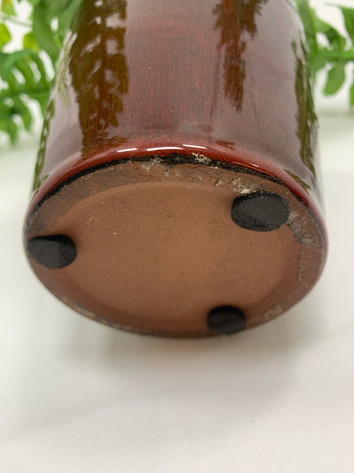 FAUX FERN IN BROWN CERAMIC POT.